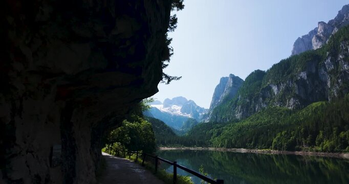 Scenic Path Along Gosausee Lake with Dachstein Mountains and Rock Overhang