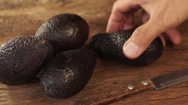 Ripe hass avocado fruit on wooden background. Healthy fruits concept. Selective focus and free space for text.