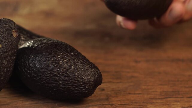 Ripe hass avocado fruit on wooden background. Healthy fruits concept. Selective focus and free space for text.