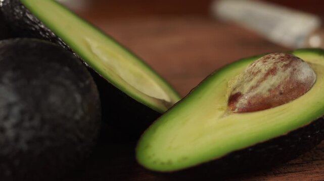 Ripe hass avocado fruit on wooden background. Healthy fruits concept. Selective focus and free space for text.