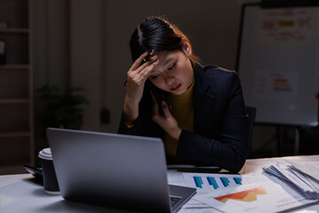 Business, tired asian woman with burnout, night and planning of budget, stress and sleepy in office. Exhausted, entrepreneur and working late on desk, overtime and person with fatigue and deadline
