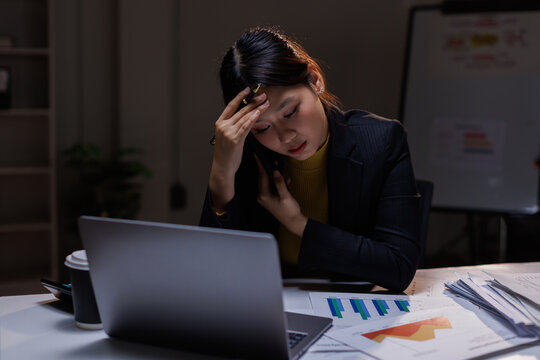 Business, tired asian woman with burnout, night and planning of budget, stress and sleepy in office. Exhausted, entrepreneur and working late on desk, overtime and person with fatigue and deadline

