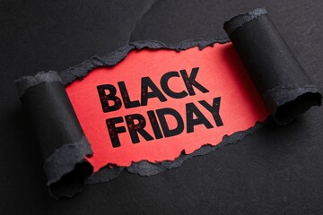 Torn black paper revealing red and black text BLACK FRIDAY