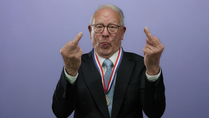 Senior man in suit with medal making gesture against purple background