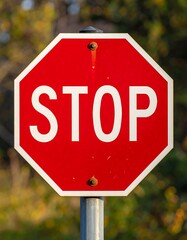 A vibrant red octagonal sign showing the word "STOP" with metal post