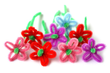 Colorful handmade flowers crafted from soft chenille stems or pipe cleaners, symbolizing creativity, imagination, and playful art. Perfect for DIY projects, crafts, and educational activities.    