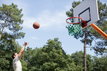 sportive athlete performing slam dunk on the court © auremar