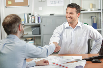 men shaking hands in the office