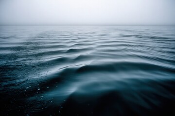 Fototapeta premium Captivating expanse of tranquil waters reflecting subtle light amidst a mysterious foggy atmosphere evoking serene introspection and a sense of calm contemplation in a meditative aquatic