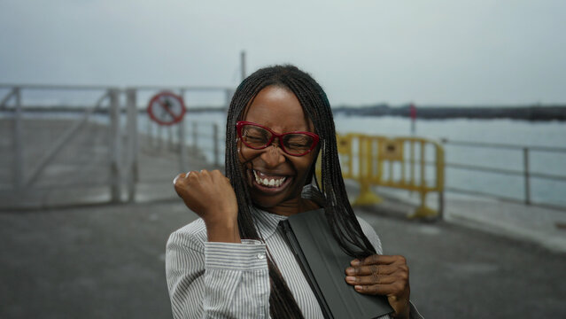 Woman smiling with tablet on promenade beside sea showcasing happiness connectivity and technology - Powered by Adobe
