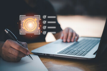Business planning concept and strategic goal setting and with a businessman pointing at a target icon and checklist. Ideal for success, productivity, project execution and leadership content.