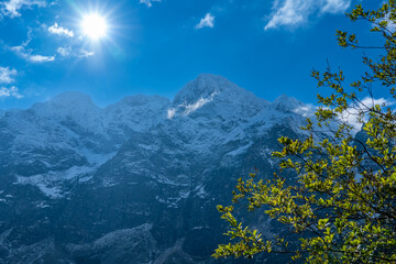 Bright Sun Over Sea Eye (Morskie Oko) Lake and Snowy Tatra Peaks, Zakopane, Poland © Marcin