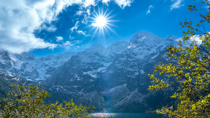 Sun Over Morskie Oko (Sea Eye) Lake and Snowy Tatra Peaks, Zakopane, Poland © Marcin
