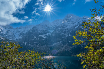 Sunburst over Morskie Oko Lake and Snowy Tatra Mountains, Zakopane, Poland © Marcin