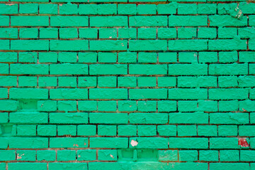 Old green brick wall with peeling paint texture background