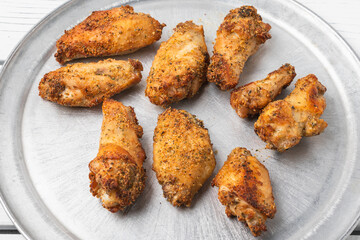 Dry rubbed chicken wings on silver tray