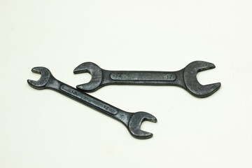 Pair Of Open End Wrenches on white surface for tools and mechanical repair. close up of wrench on white background.