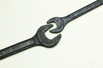 Pair Of Open End Wrenches on white surface for tools and mechanical repair. close up of wrench on white background.