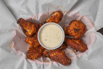 Buffalo wings served hot with a side of creamy ranch dressing.