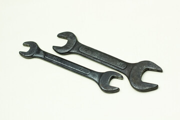 Pair Of Open End Wrenches on white surface for tools and mechanical repair. close up of wrench on white background.