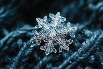A single snowflake on a blue textured knitted surface macro close-up.