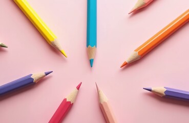 Colorful pencils arranged in circle on pink background. Vibrant art supplies for drawing, painting, and creative projects. Back to school concept, education theme.