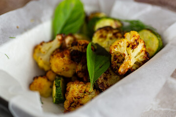 Freshly roasted zucchini and cauliflower served in baking tray