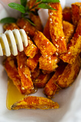 Healthy grilled pumpkin pieces drizzled with natural honey