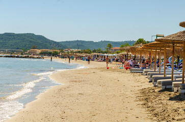 Alykes Zante Greece May 27 2025 - Holiday makers enjoying the beach in Alykes with sunbeds and beach umbrellas