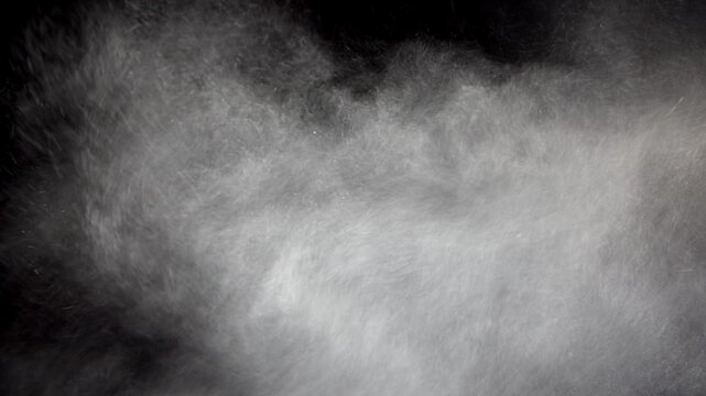 A sand or particle blizzard with black background