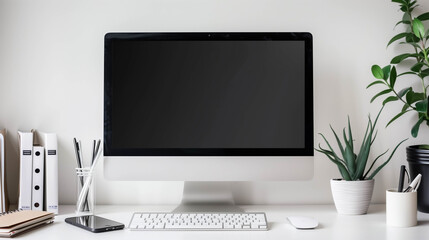 Fototapeta premium Computer desktop with plant and stationery on white table.