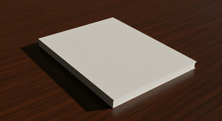 Fototapeta premium A plain, closed, white book rests diagonally on a dark, polished wooden surface, casting a soft shadow.