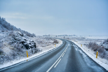 Curve of road in snowy weather for road trip in Iceland , Unpredictable weather in Iceland.