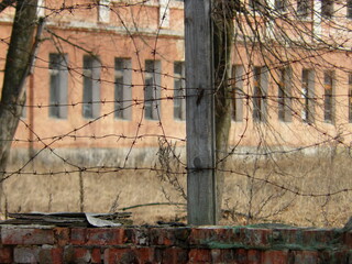 View of the old building through the barbed wire