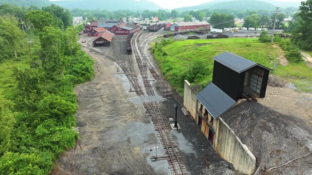 Discover the remnants of an old railroad yard in Green County, featuring abandoned buildings and overgrown tracks.
