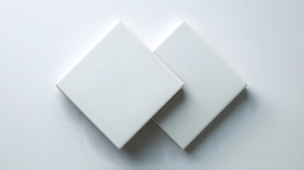 Two white square boxes arranged diagonally on a white background.
