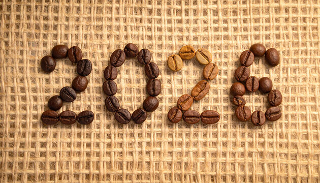 The year 2026 spelled out with coffee beans of different roasts on a textured burlap background.