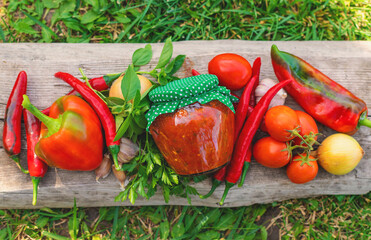 Adjika in a jar, canned. Selective focus.