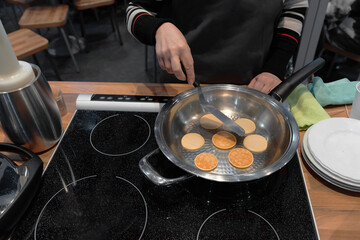 Frying mini pancake cereal in a nonstick frying pan.