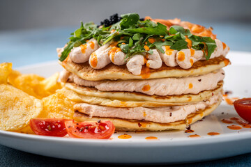 savory pancakes with creamy sauce and arugula
