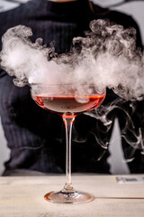 smoking red cocktail in elegant glass close-up