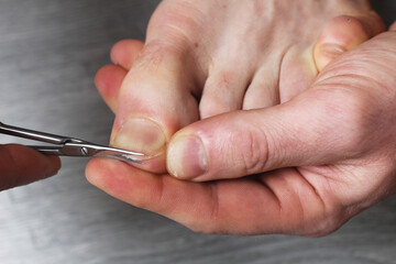 cutting off toenails close-up. Pedicure at home