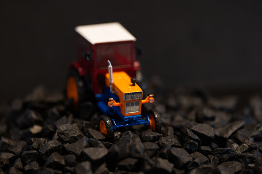 Bucharest Romania 11 October 2025.A detailed photograph of a vintage Romanian UTB 650 tractor captured on a black background, surrounded by black stones.