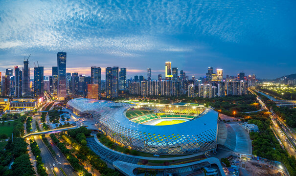 Panoramic view of a modern city skyline with commercial skyscrapers at dusk in Shenzhen.