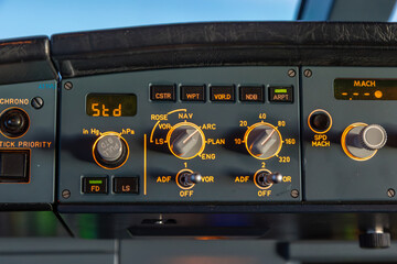 Close-up of cockpit flight instruments and navigation display in airplane