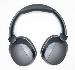 black headphones bent in photo with white background