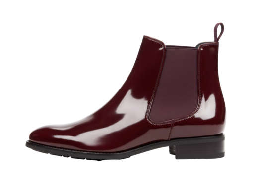 Isolated dark red patent leather Chelsea boot with elastic side panels and black block heel