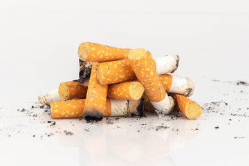 Pile of Cigarette Butts on White Background
