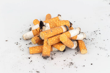 Pile of Cigarette Butts on White Background