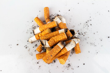 Pile of Cigarette Butts on White Background